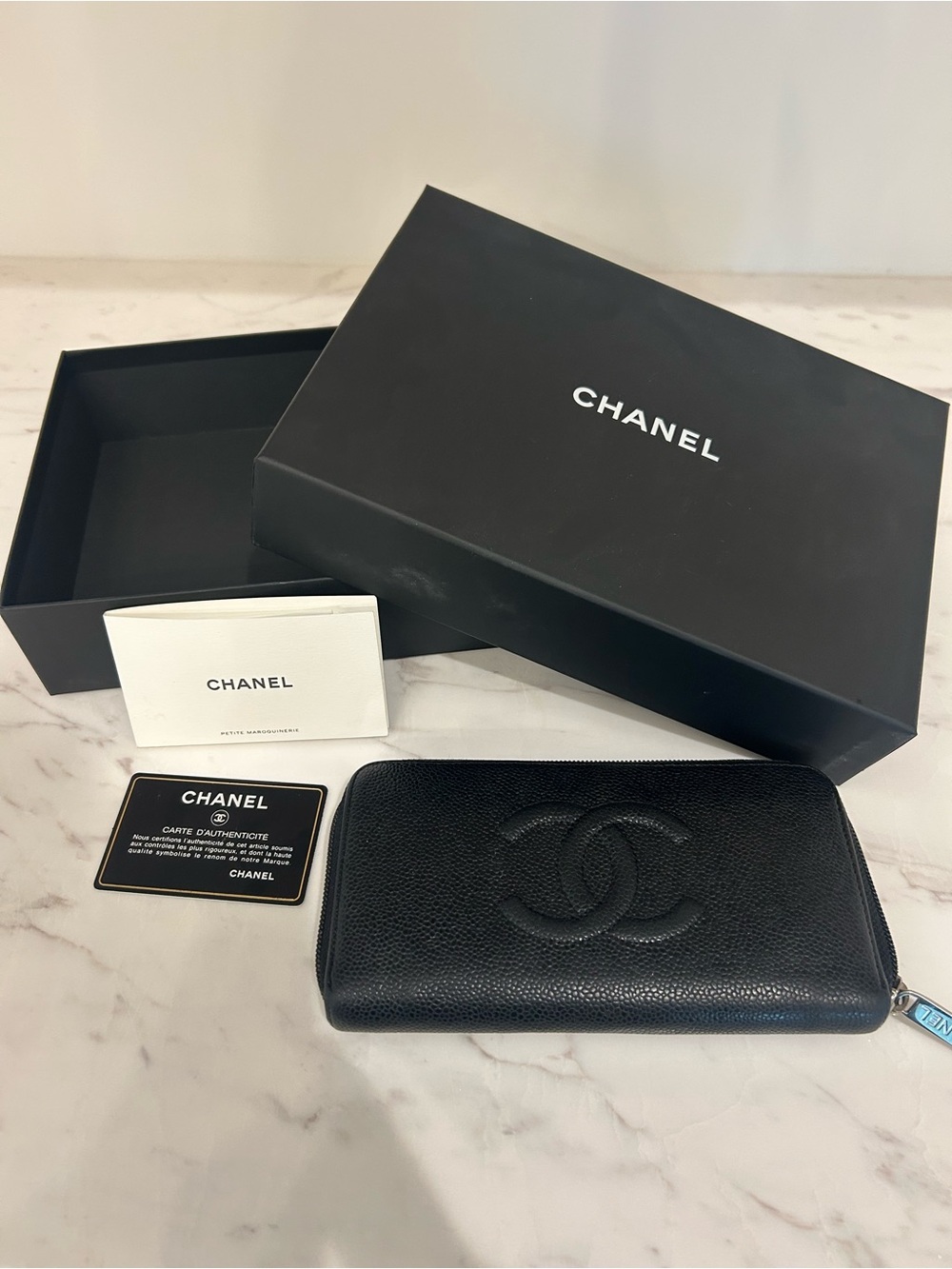 CHANEL Black Quilted Zip Around Wallet with Embossed CC